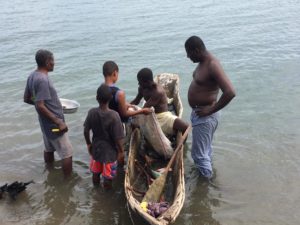Pastor Harry negotiating fresh fish and crabs.
